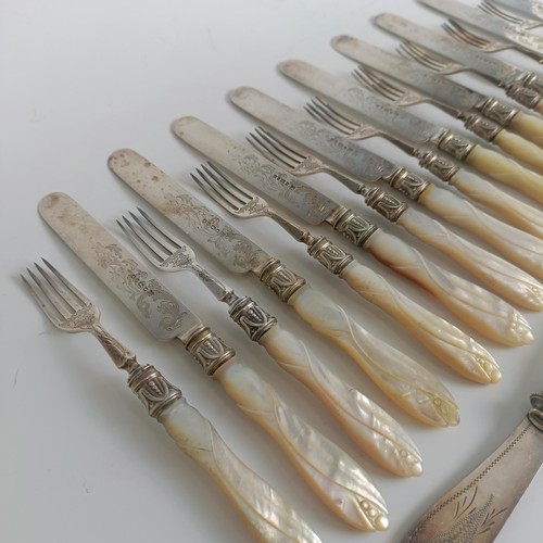 99 - A matched set of twelve silver plated dessert knives and forks, with silver collars and carved mothe... 