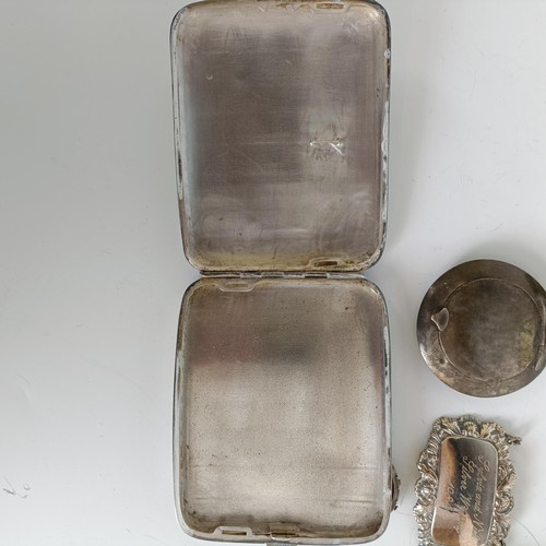 106 - A silver coloured metal cigarette case, two compacts, a baby's rattle, a wine label, a silver coin m... 