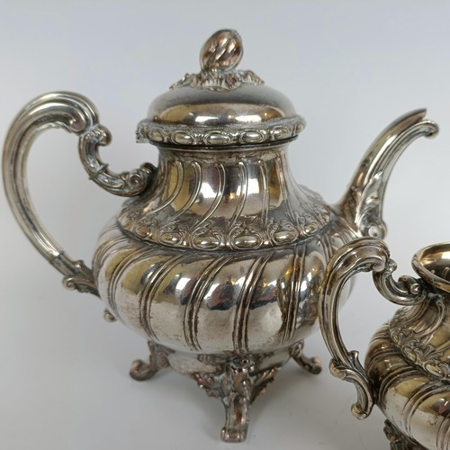 116 - A Continental silver coloured metal teapot, and a matching cream jug, stamped .800 (2)