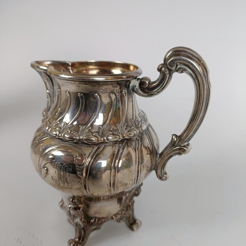 116 - A Continental silver coloured metal teapot, and a matching cream jug, stamped .800 (2)