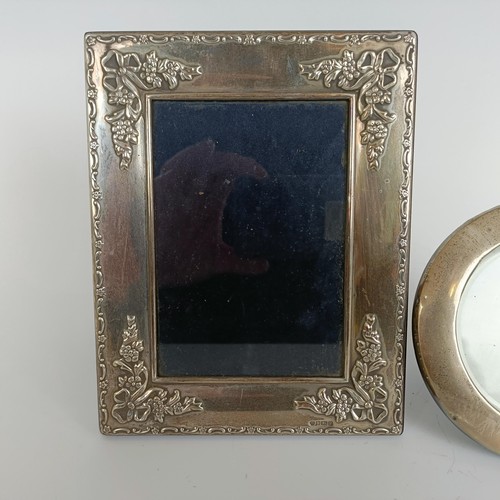 146 - A modern silver photograph frame, Sheffield 1966, 18 x 14 cm, and a round photograph frame, 12 cm di... 