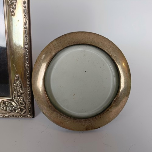 146 - A modern silver photograph frame, Sheffield 1966, 18 x 14 cm, and a round photograph frame, 12 cm di... 