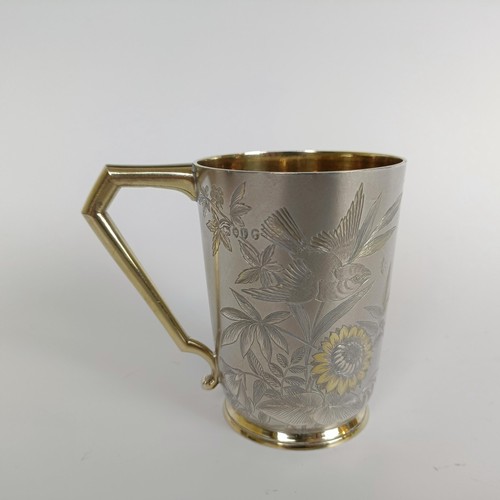 149 - A Victorian silver mug, engraved birds and foliage, London 1884