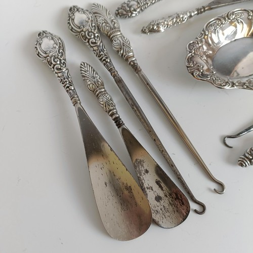 151 - Two matching pairs of silver handled button hooks and shoehorns, other Art Nouveau brushes and a sil... 