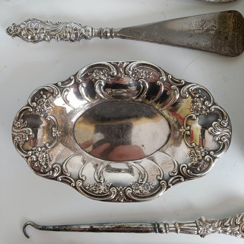 151 - Two matching pairs of silver handled button hooks and shoehorns, other Art Nouveau brushes and a sil... 