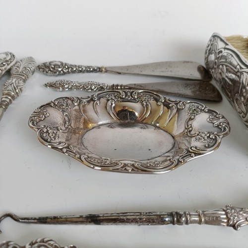 151 - Two matching pairs of silver handled button hooks and shoehorns, other Art Nouveau brushes and a sil... 