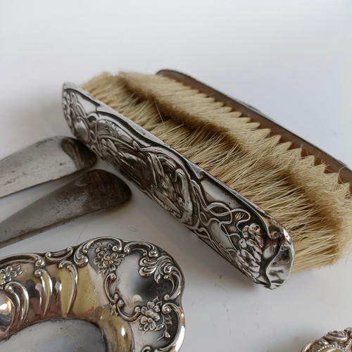 151 - Two matching pairs of silver handled button hooks and shoehorns, other Art Nouveau brushes and a sil... 