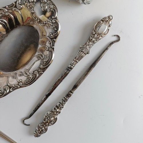 151 - Two matching pairs of silver handled button hooks and shoehorns, other Art Nouveau brushes and a sil... 