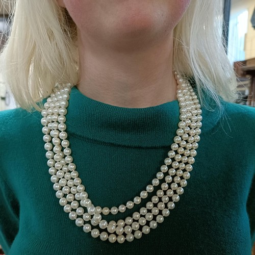 301 - A four strand cultured pearl necklace, with an impressive diamond clasp, the largest diamond approx.... 