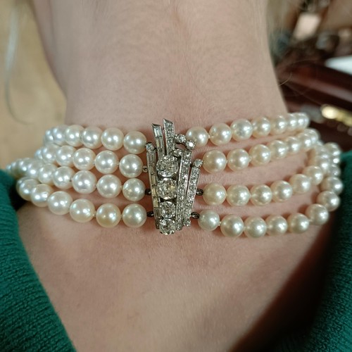 301 - A four strand cultured pearl necklace, with an impressive diamond clasp, the largest diamond approx.... 