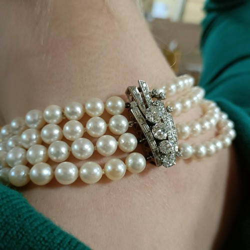 301 - A four strand cultured pearl necklace, with an impressive diamond clasp, the largest diamond approx.... 