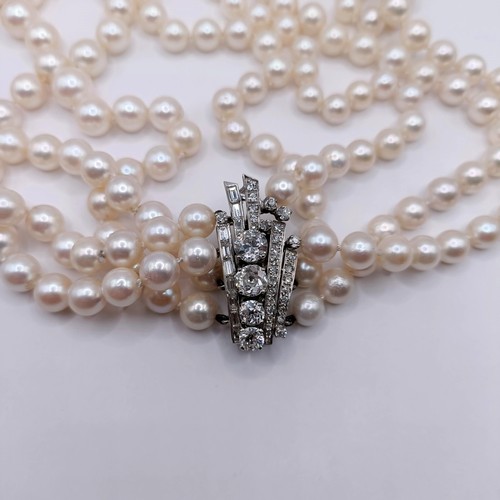 301 - A four strand cultured pearl necklace, with an impressive diamond clasp, the largest diamond approx.... 