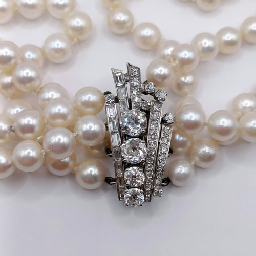 301 - A four strand cultured pearl necklace, with an impressive diamond clasp, the largest diamond approx.... 