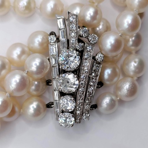 301 - A four strand cultured pearl necklace, with an impressive diamond clasp, the largest diamond approx.... 