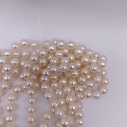 301 - A four strand cultured pearl necklace, with an impressive diamond clasp, the largest diamond approx.... 