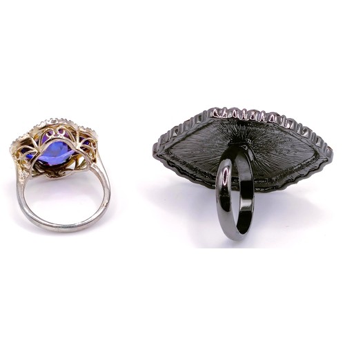 303 - A silver purple and white stone dress ring, ring size L, and a black stone dress ring, ring size K (... 