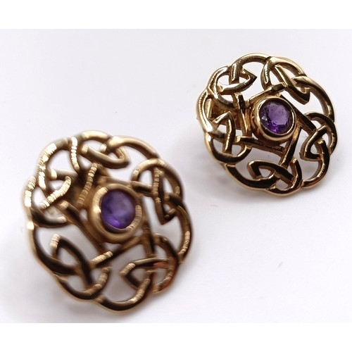 309 - A pair of 9ct gold and amethyst Celtic style stud earrings