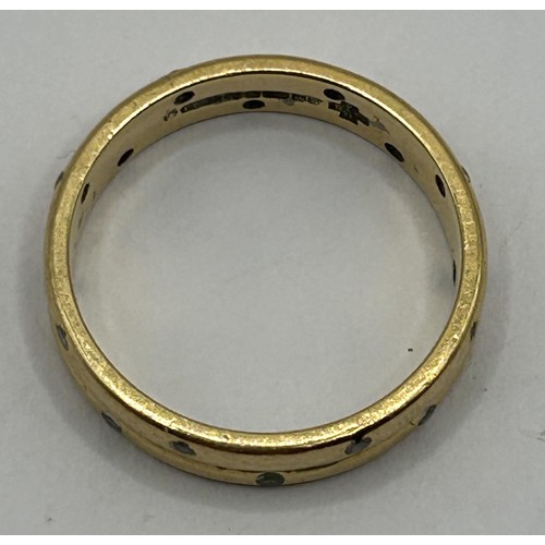 319 - An 18ct gold and diamond band, ring size K, 3.8 g all in