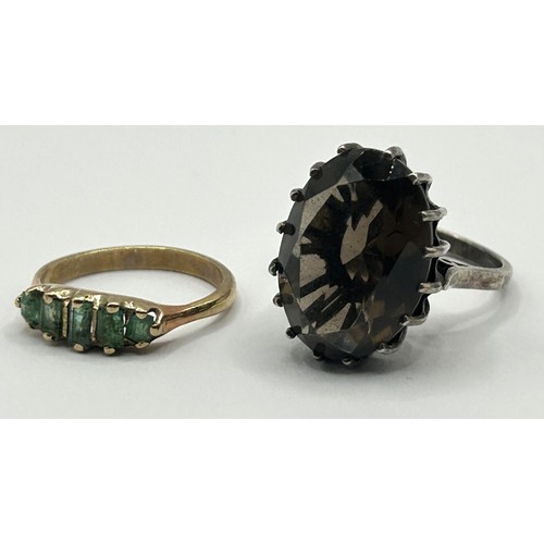 324 - A 9ct gold and green stone ring, ring size J, and a brown stone dress ring, ring size N (2)