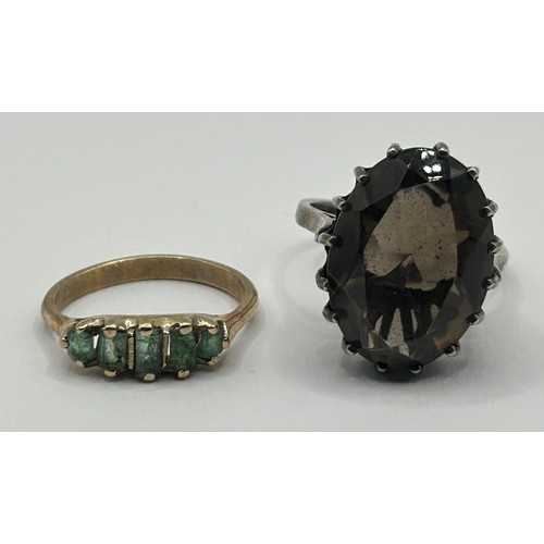 324 - A 9ct gold and green stone ring, ring size J, and a brown stone dress ring, ring size N (2)