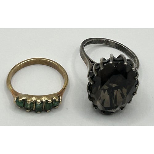 324 - A 9ct gold and green stone ring, ring size J, and a brown stone dress ring, ring size N (2)