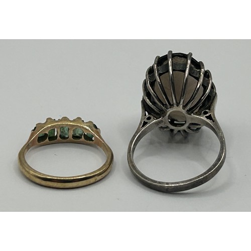 324 - A 9ct gold and green stone ring, ring size J, and a brown stone dress ring, ring size N (2)