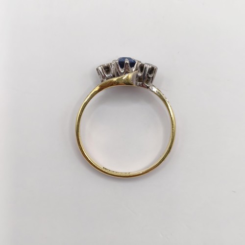 335 - An 18ct gold, sapphire and diamond crossover ring, ring size J...