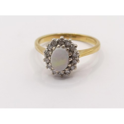 336 - An 18ct gold, diamond and opal ring, ring size K...