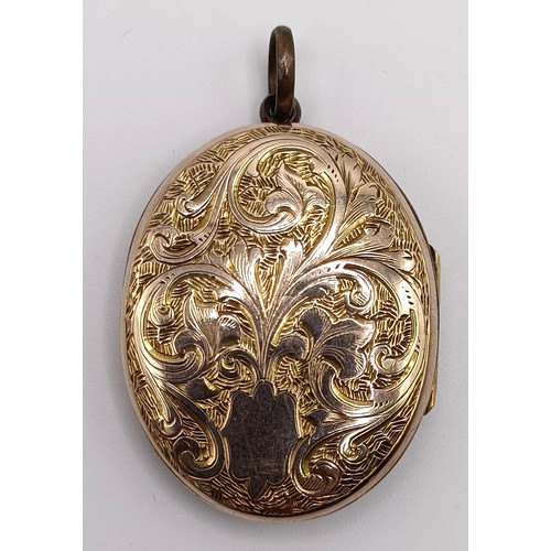 337 - An early 20th century silver gilt and enamel oval locket