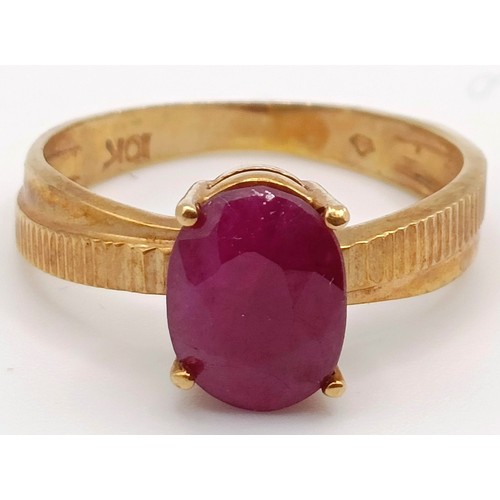 348 - A 10ct gold and red stone ring, ring size G, and a silver and purple stone ring, ring size K (2)