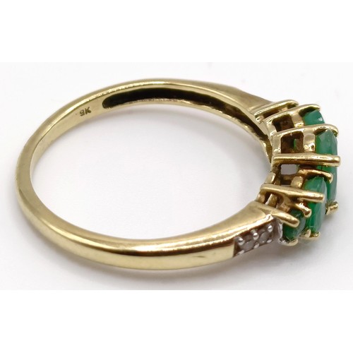 362 - A 9ct gold ring, in the form of a theatrical mask, ring size C, 2 g, and a 9ct and green stone ring,... 