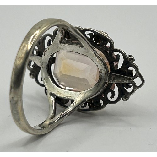 389 - A Bernard Instone silver coloured metal and peach coloured stone ring