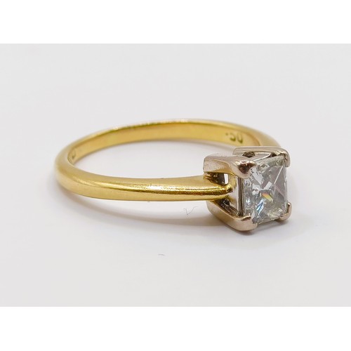 393 - An 18ct gold and solitaire ring, with an emerald cut diamond, ring size J