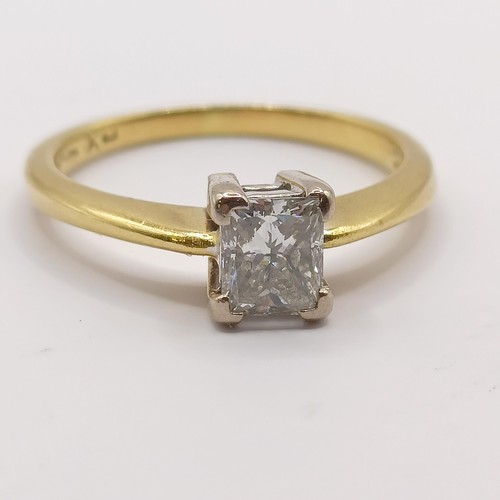 393 - An 18ct gold and solitaire ring, with an emerald cut diamond, ring size J