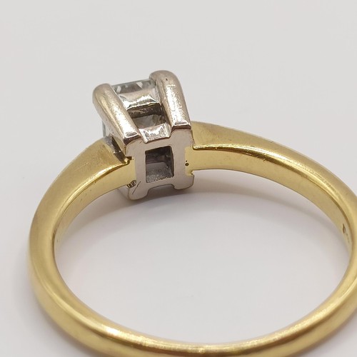 393 - An 18ct gold and solitaire ring, with an emerald cut diamond, ring size J