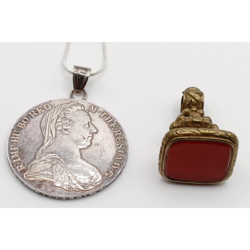 404 - A gilt metal seal, and a Thaler pendant coin on a chain