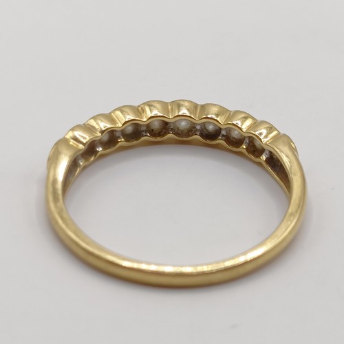 405 - An 18ct gold and diamond half eternity ring, ring size P