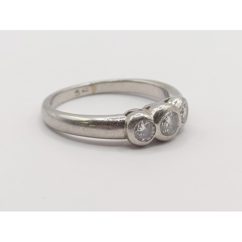 407 - A platinum and diamond three stone ring, ring size M