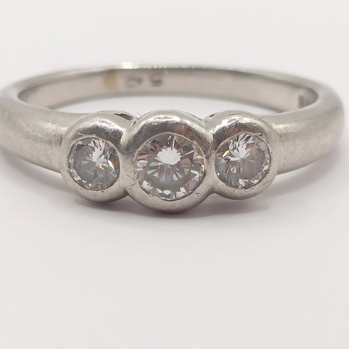 407 - A platinum and diamond three stone ring, ring size M