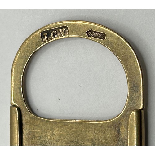 411 - A 9ct gold cigar cutter, 10 g (all in)