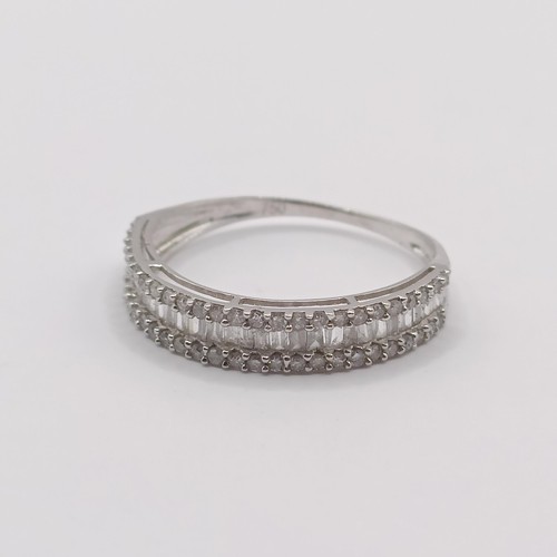 418 - An 18ct white gold and baguette cut diamond half hoop ring, ring size L