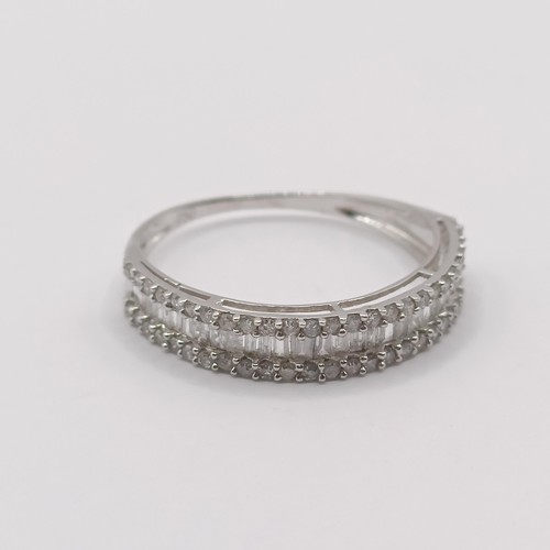 418 - An 18ct white gold and baguette cut diamond half hoop ring, ring size L