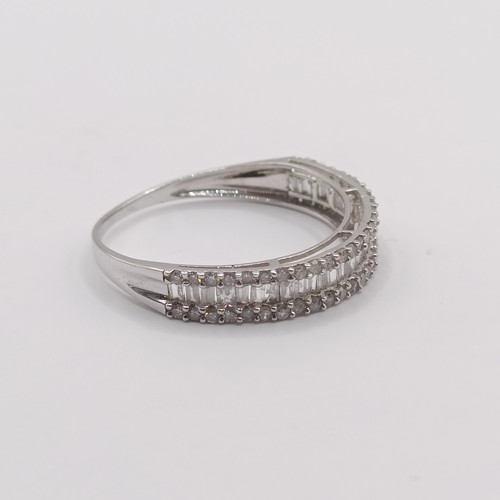 418 - An 18ct white gold and baguette cut diamond half hoop ring, ring size L