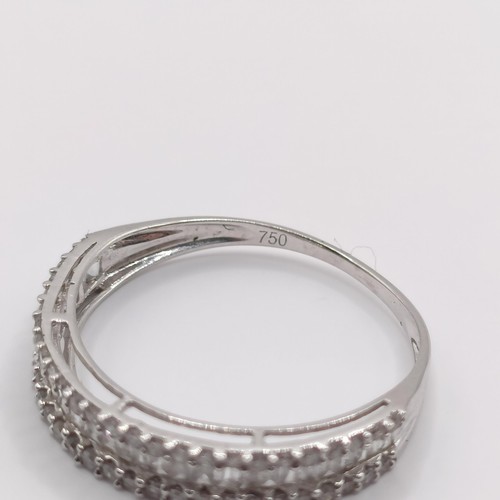 418 - An 18ct white gold and baguette cut diamond half hoop ring, ring size L