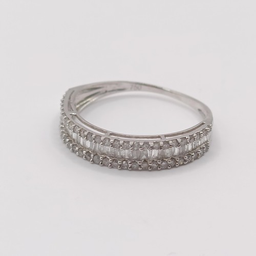 418 - An 18ct white gold and baguette cut diamond half hoop ring, ring size L