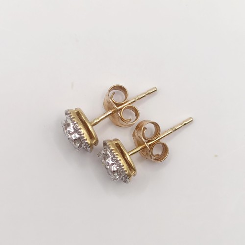 424 - A pair of 9ct gold and diamond ear studs