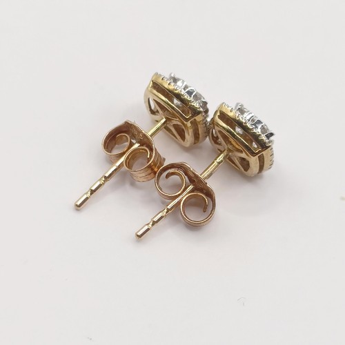 424 - A pair of 9ct gold and diamond ear studs