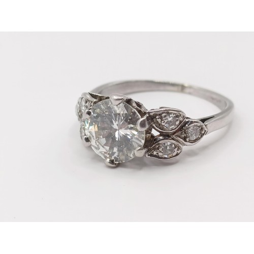 426 - A platinum and diamond ring, the central stone approx. 1.65ct, with further diamonds to the shoulder... 