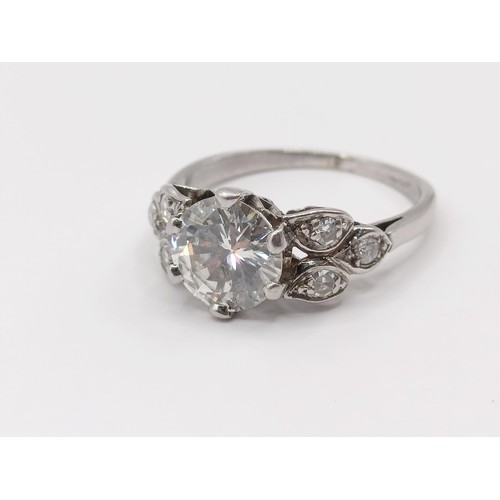 426 - A platinum and diamond ring, the central stone approx. 1.65ct, with further diamonds to the shoulder... 