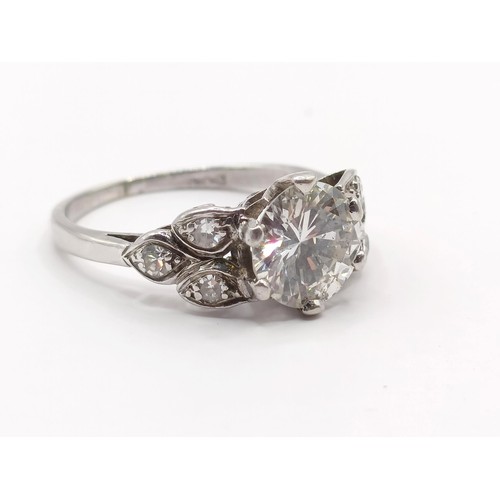 426 - A platinum and diamond ring, the central stone approx. 1.65ct, with further diamonds to the shoulder... 